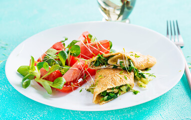 Omelette rolls on a plate. Homemade fried omelet rolls with chopped greens. Healthy low carb recipe.