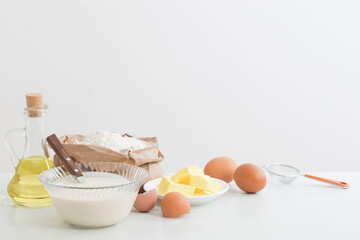 dough in glass plate and products for its preparation on  white background
