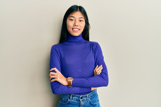 Young chinese woman wearing casual clothes happy face smiling with crossed arms looking at the camera. positive person.