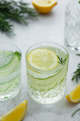 Immune boosting detox drink. Cold cocktail summer beverage with cucmbers, lemons and rosemary.