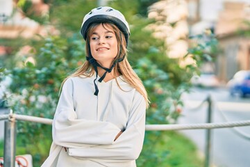 Caucasian sporty teenager girl smiling happy wearing bike helmet at the city.