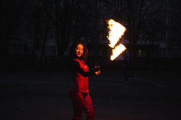 Fototapeta na wymiar A girl shows a fire show