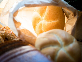 Golden bread roll in a paper bag