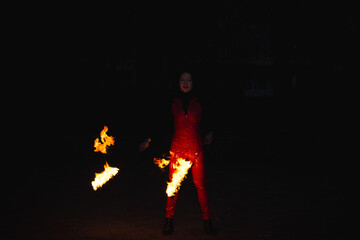 A girl shows a fire show