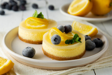 Cheesecake lemon tart cake or pie, with fresh lemon, blueberry and mint. White background, lifestyle healthy desert.