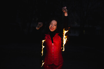 A girl shows a fire show