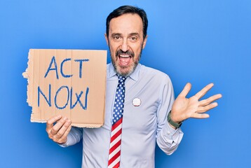 Middle age handsome business man wearing usa tie holding banner with act now message celebrating achievement with happy smile and winner expression with raised hand
