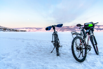 Fototapeta na wymiar Two bycicles near Ogoy Island in Baikal lake in winter. Irkutsk Oblast, Russia