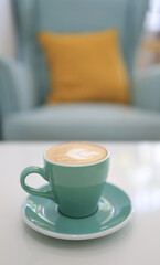 A coffee mug with latte art in a coffee shop.