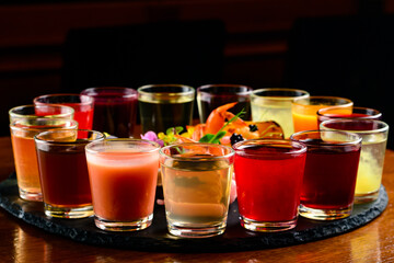 Fototapeta na wymiar Colourful set of alcoholic cocktails in shot glasses shooters