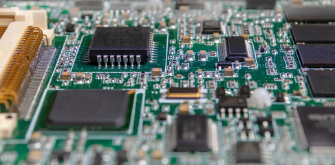 printed circuit board with surface mounted passive and active circuit components close up