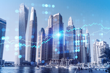 Skyscrapers of Dubai business downtown. International hub of trading and financial services of Western Asia. FOREX graph and chart concept. Double exposure. Dubai Canal waterfront.