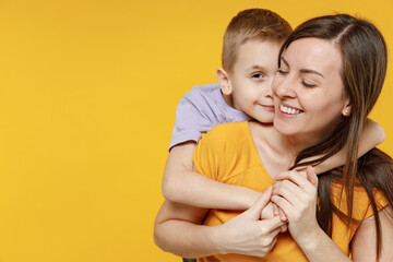 Happy young woman have fun with cute child baby boy 5-6-7 years old in violet t-shirt. Mommy little...