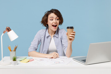 Young excited employee business woman in casual shirt sit work at white office desk with pc laptop...