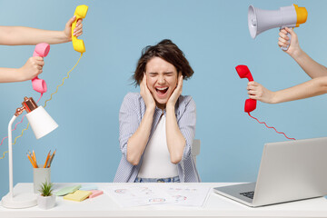 Young confused stressed business woman in shirt sit work at office desk with pc laptop giving...