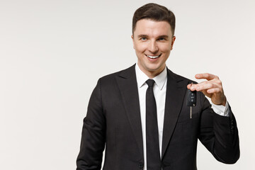 Young rich employee business corporate lawyer man 20s wearing classic formal black grey suit shirt tie work in office holding car keys fob keyless system isolated on white background studio portrait.