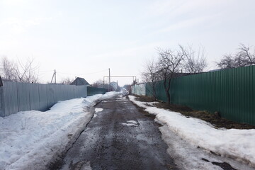 dirty rural road in early spring in Russia