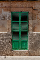 Fototapeta na wymiar green window with shutters