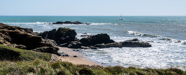 Vendée, France: Photo of the bay of the Grosse Terre lighthouse at rising tide, not far from Trou du Diable, a sea cave on the Corniche de Riez, in the town of Saint-Hilaire-de-Riez, March 2021. 