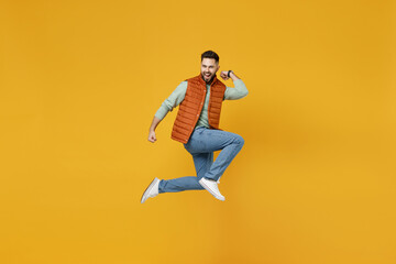 Full length side view young overjoyed happy fun caucasian man 20s years old wearing orange vest...