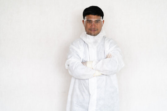 Portrait  Asian Doctor In Full Protective Equipment Protective PPE Suit Wearing Face Mask And Eyeglasses.