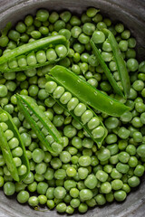 Fresh green peas. Close-up. Top view. Fresh green peas pods and green peas in bowl. 