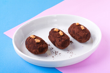 Kartoshka cake on the ceramic plate on colorful background. Russian potato-shaped dessert