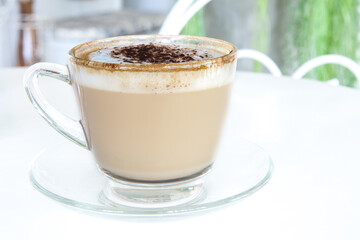 Glass of Cappuccino Coffee serve on white table