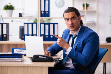 Young handsome employee sitting in the office