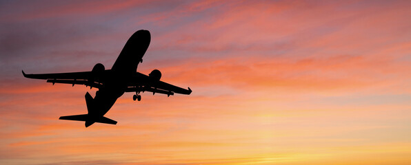 Silhouette of airplane in the sunset