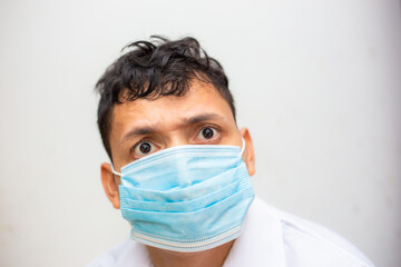 Young asian men wear surgical mask on white background