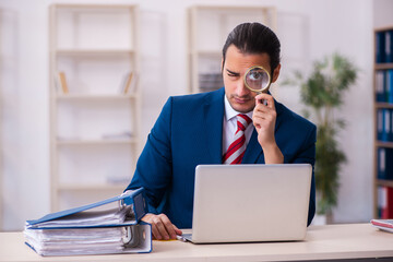 Fototapeta premium Young businessman employee sitting in the office