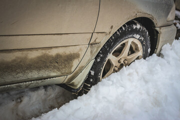 Old dirty car in a snowdrift