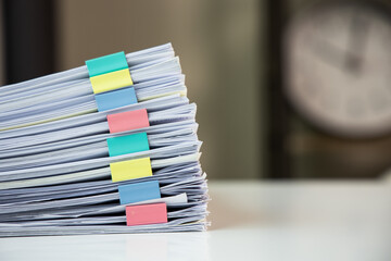 Piles of white papers work large piles of papers stacked together. On the desk in the office with...