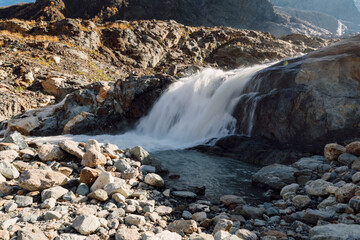 Powerful waterfall with rocks in the mountains