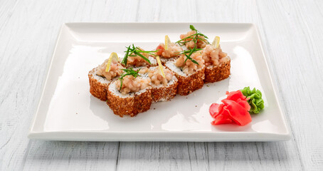 Hot fried Sushi Roll with salmon, avocado and cheese. Japanese food.