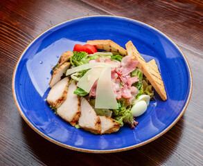 Chicken Caesar Salad. Caesar Salad with grilled chicken on plate. Grilled chicken breasts and fresh salad in plate