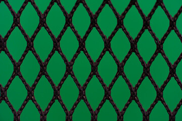 Fototapeta premium Silhouette of ropes that are bound together in a grid. on abstract green color.