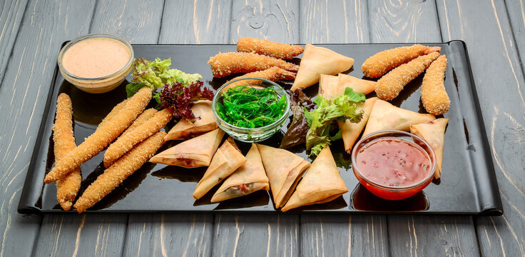 Many types of savoury snack with different sauces and salads