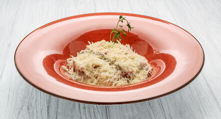 Pasta Carbonara. Spaghetti with bacon and parmesan cheese. Pasta Carbonara on color plate and wooden background. Italian food concept. Top view.