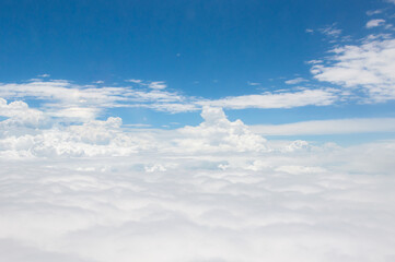 Naklejka na ściany i meble over the clouds,Blue sky with tiny clouds background Beautiful natural view from airplane window above. Background or Wallpaper.blue sky and cloud sky nature.Top view of aircraft