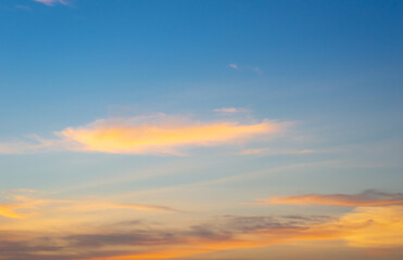 Beautiful sky painted by the sun leaving bright golden shades.Dense clouds in twilight sky in winter evening.Image of cloud sky on evening time.Evening sky scene with golden light from the setting sun