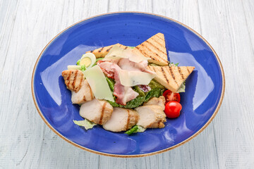 Chicken Caesar Salad. Caesar Salad with grilled chicken on plate. Grilled chicken breasts and fresh salad in plate