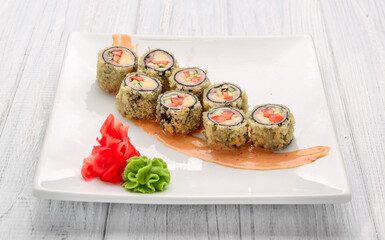Hot fried Sushi Roll with salmon, avocado and cheese. Japanese food.