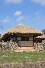 Fototapeta na wymiar Traditional South Korean thatched roofed house. Roof made of straw.