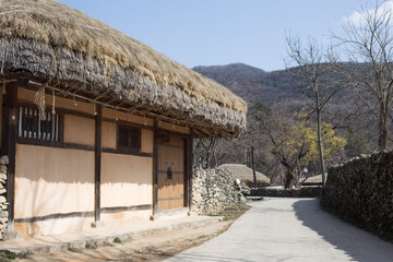 Traditional South Korean thatched roofed house. Roof made of straw.