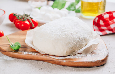 The ingredients for homemade Margherita pizza on stone background.
