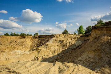 Sand quarry board on a sunny day and blue sky with clouds.