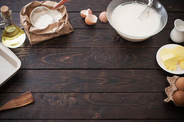 dough  and products for its preparation on  dark wooden background