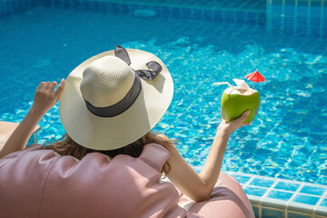 Cute girl is relaxing in the pool.